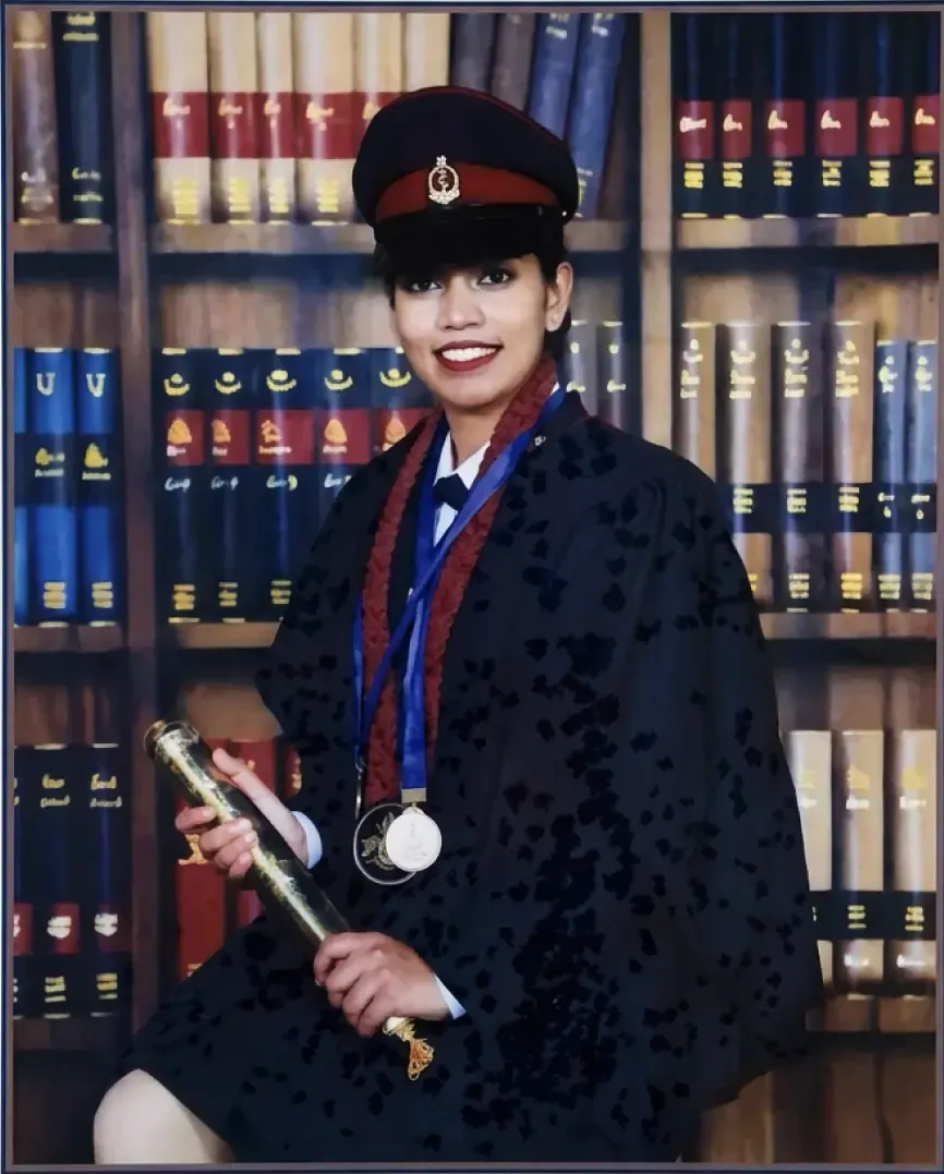 Dr Dinelka Samarajeewa in graduation robes and cap holding her degree scroll