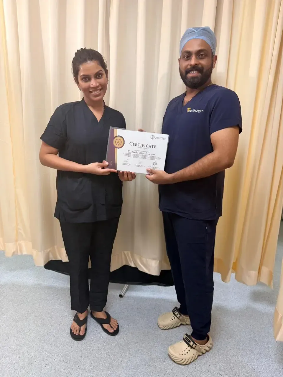 Dr Dineli receiving a hands on training certificate from a colleague at the clinic